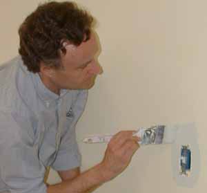 Photo: Patrick Dare paints around light switch.